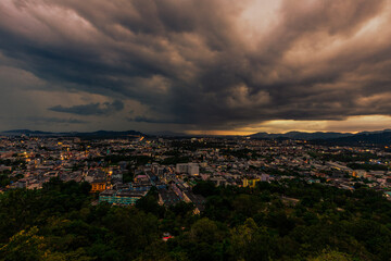 Nature background from Phuket city viewpoint, Khao Rang viewpoint, with black rain clouds covering the evening, changing seasons according to the time of the rainy season.