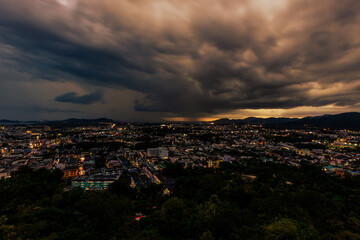 Nature background from Phuket city viewpoint, Khao Rang viewpoint, with black rain clouds covering the evening, changing seasons according to the time of the rainy season.