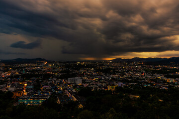 Nature background from Phuket city viewpoint, Khao Rang viewpoint, with black rain clouds covering the evening, changing seasons according to the time of the rainy season.
