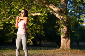 Young woman exercising in the nature in summer