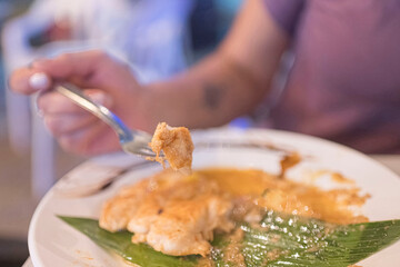 Close-up of a woman's hands using cutlery while eating