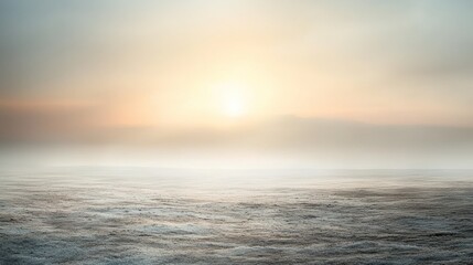 Fototapeta premium Misty Sunrise Over Frozen Field: A Serene Winter Landscape