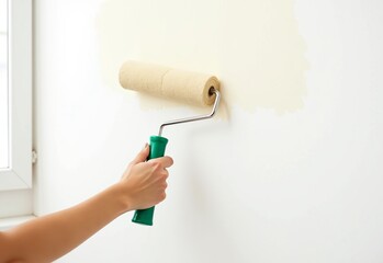 Close-Up Hand Painting: White Wall, Green Handle Brush, Beige Paint, Clear Background, Copy Space, 2/3 Format, Detailed Strokes, Stock Photo, Product Placement.

