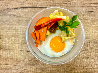 Healthy Breakfast, Oatmeal with milk and fried vegetarian, carrot and cauliflower.