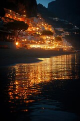 Fototapeta premium Serene evening lights reflect on the calm waters of the coastline near Positano, Italy