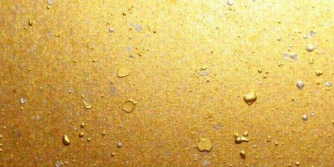 Abstract Golden Texture with Scattered Metallic Droplets and Specks