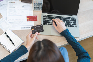 Internet banking, Online shopping at home, asian young woman hand in typing on keyboard, holding...