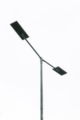 Street Light Pole with Double Rectangular Lamp Heads on a Cloudy Day Minimalist Scene