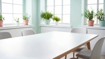 A close-up view of a modern dining table in a bright, airy pastel-colored dining room with morning light streaming through large windows. 