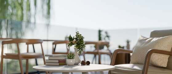 An armchair and a coffee table on a beachfront balcony lounge of a hotel or restaurant.