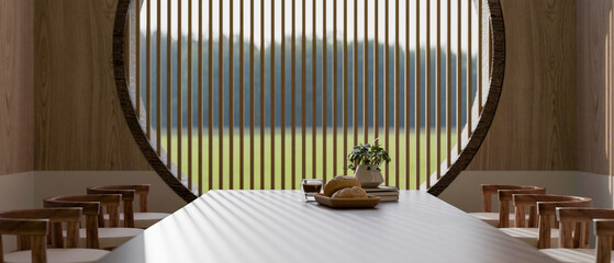 A close-up of a dining table with wooden armchairs in a cosy, minimalist Japandi dining room.