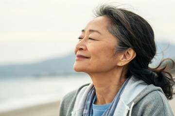 A serene woman enjoys a moment of tranquility by the beach, capturing the essence of peace and introspection.
