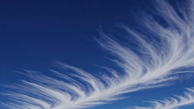 Wispy cirrus clouds against clear blue sky, nature and tranquility concept