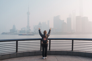young Asian woman wearing respiratory mask protect and filter pm or particulate matter against bad...