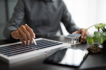 Solar panels green energy Business man working  green eco friendly office business creative idea Planing Bio economy for business eco friendly professional Engineer sustainable electricity.
