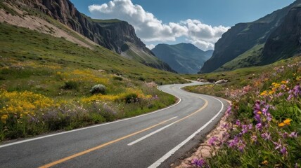 Fototapeta premium Winding Mountain Road with Wildflowers and Mountain Scenery under a Blue Sky