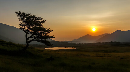 Solitary tree silhouetted against sunset over mountain valley, tranquil landscape ideal for travel brochures
