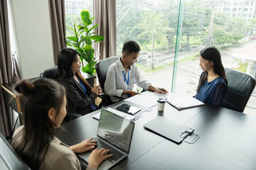 Asian woman interviewed for job by human resources staff