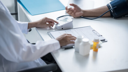 Medical Examination Doctor Conducting Blood Pressure Test on Patient for Diagnosisใ