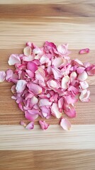Delicate Pink Rose Petals Scattered on Wooden Surface