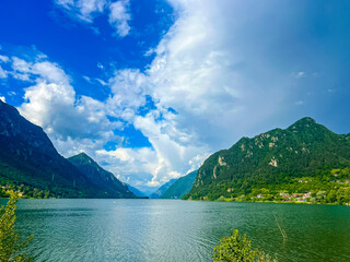 Serene Lake Idro Surrounded by Majestic Mountains and Cloudy sky, Italy, Crone