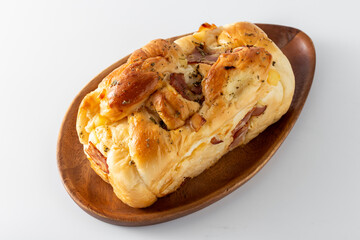 Hotdog bun with ham and cheese on white background