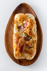 Hotdog bun with ham and cheese on white background