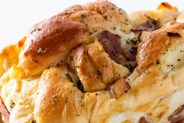 Hotdog bun with ham and cheese on white background