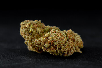 Dried cannabis flowers on black background