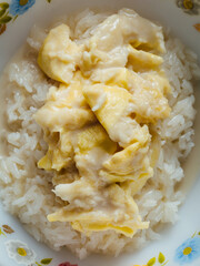 Sticky rice with durian on wooden background