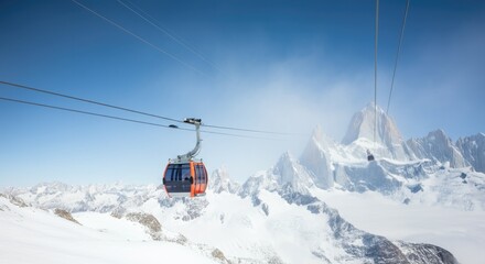 An orange cable car travels along a snowy mountain range under a bright blue sky, offering scenic views of the peaks and winter landscape.