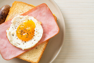 bread toasted cheese topped ham and fried egg with pork sausage