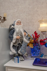 Santa Claus toy figure on white shelf .
