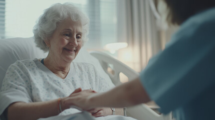 Obraz premium Compassionate Care: An elderly woman smiles warmly as a caregiver gently holds her hands, creating a tender moment of connection and comfort in a hospital or care facility. 