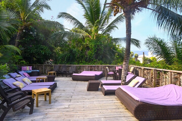 Fototapeta premium Relaxation area with sun beds in a tropical resort