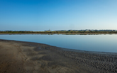 Cheetham Wetlands in Point Cook, Victoria, Australia, An Australian coastal nature landscape with a distant view of suburban residential houses. Concept of a living environment near a conservation
