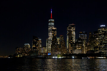 A vibrant sunset panorama of Manhattan downtown skyline, viewed from the river