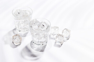Crystal-clear glasses filled with chilled water and ice cubes
