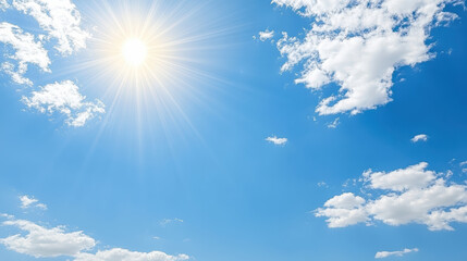 Bright blue sky with sun rays and fluffy white clouds creating cheerful atmosphere