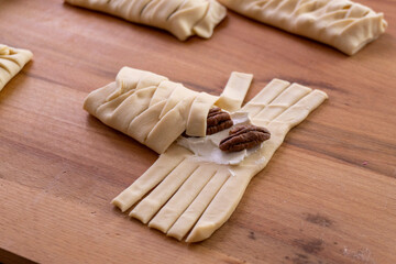 The process of making puff pastry with cream cheese and pecans. Baking concept. Homemade food. Baking cakes in the oven.