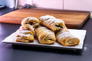Delicious homemade cakes. Puff pastry with cherries, generously sprinkled with icing sugar on top. Delicious fresh buns close up view