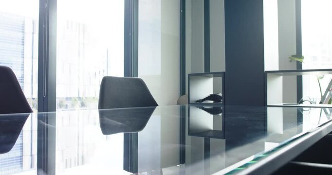 Empty conference room with glass table and chairs, modern office setting, copy space