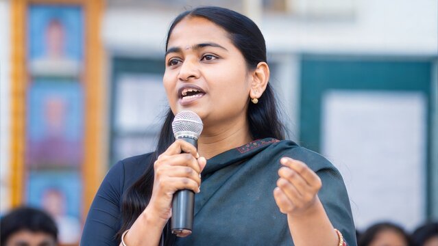 Indian female leader speaking at an educational event or seminar.