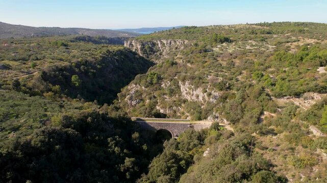 Beautiful aerial drone shot of a valley on the Brac island in Croatia, between the towns of Sutivan, Milan and Supetar. Shot taken during the olive harvest season and traditional olive oil production.