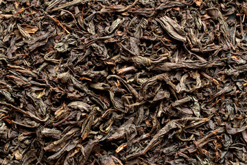 The texture of large-leaf black tea. Dried tea leaves close-up.
