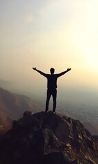 a silhouette of a man holding his arms up
