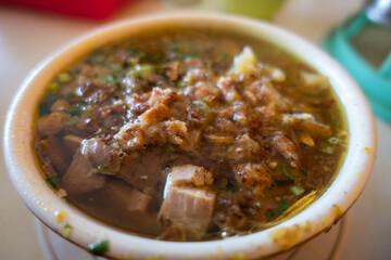 Close-Up of an Indonesian Traditional Meat Soup Bowl with Flavorful Garnishes. Beef Soup in a Bowl