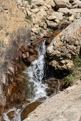 Stormy and foaming transparent waters of mountain river Abai-Su flow in thin streams among the stones and boulders created by nature. Kabardino-Balkaria. Chegemsky Nature Reserve. Autumn 2024.