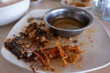 Empty Plate with Leftover Seafood and Sauce Indicating a Finished Meal