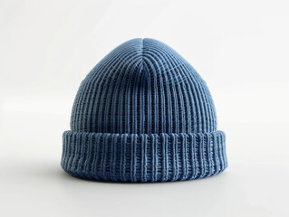 A plain blue knit beanie hat showcased in a front view, set against a clean white backdrop.